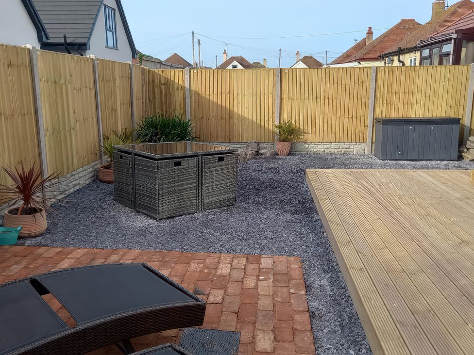 A garden with gravel and decking at Mike’s Place On The Cove Rhyl