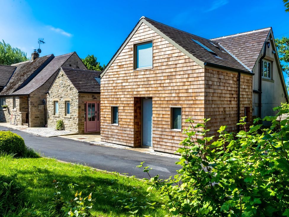 A house with a driveway and garden at 2 The Croft in Skipton