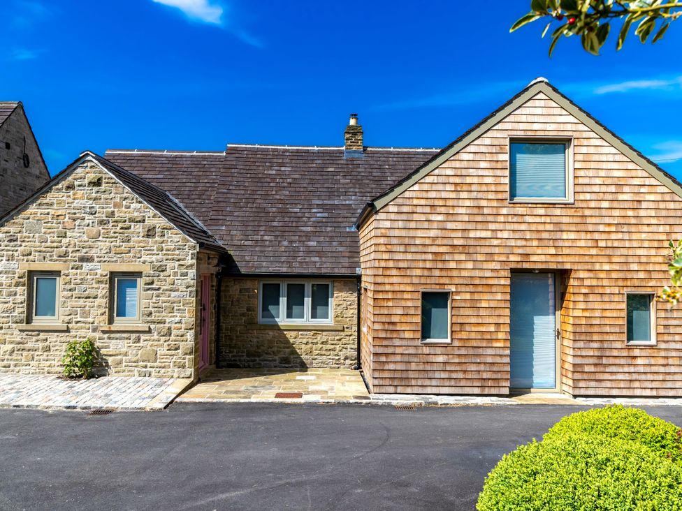 A house with stone and wooden exterior at 2 The Croft in Skipton