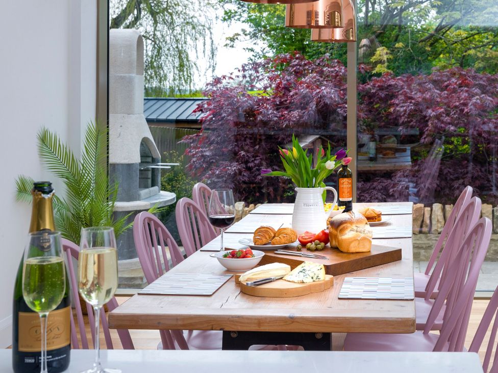A dining room with a table set for a meal at 2 The Croft in Skipton