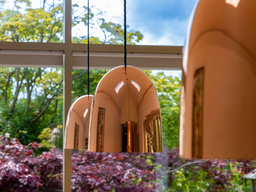 Hanging lamps near a glass window overlooking a garden at 2 The Croft Skipton