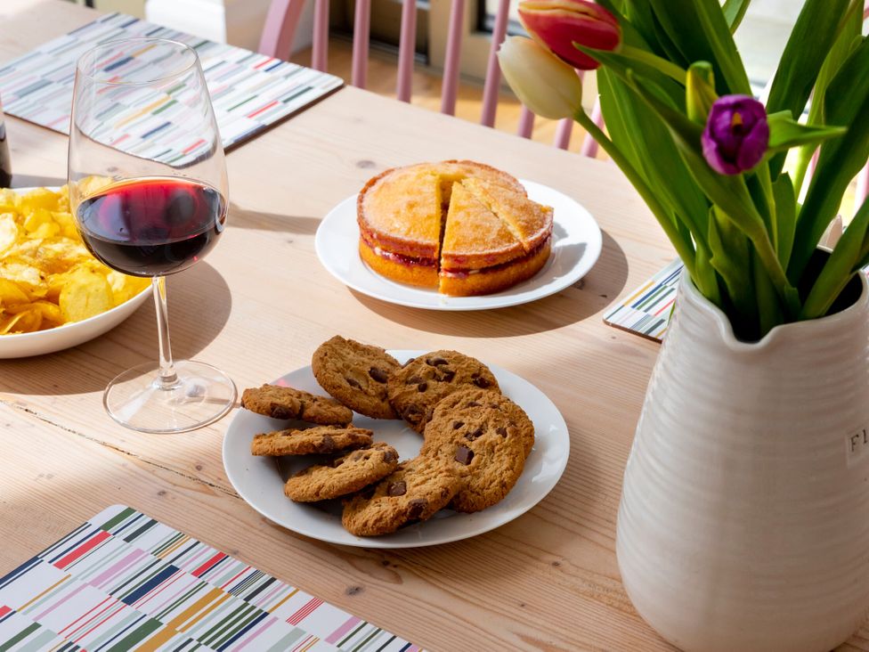 A dining room table with snacks and drinks at 2 The Croft in Skipton