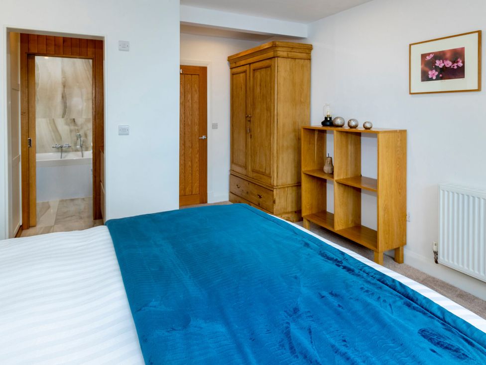 A bedroom with a bed and wardrobe at 2 The Croft in Skipton