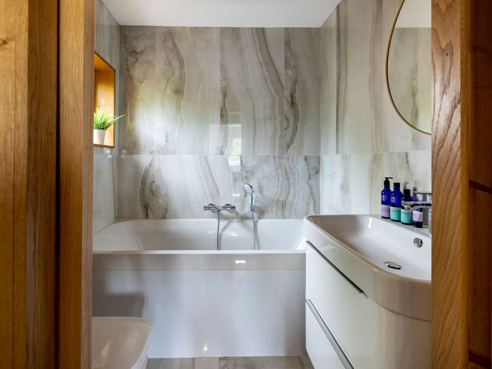 A bathroom with a bathtub and sink at 2 The Croft in Skipton