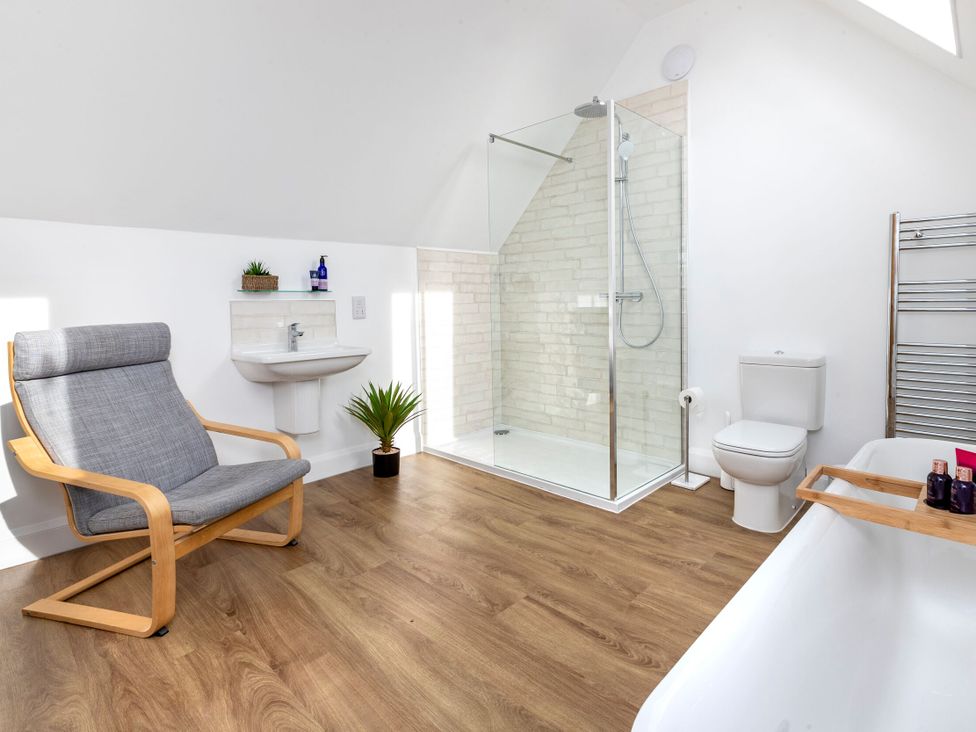 A bathroom with a shower, toilet, sink, and bathtub at 2 The Croft in Skipton