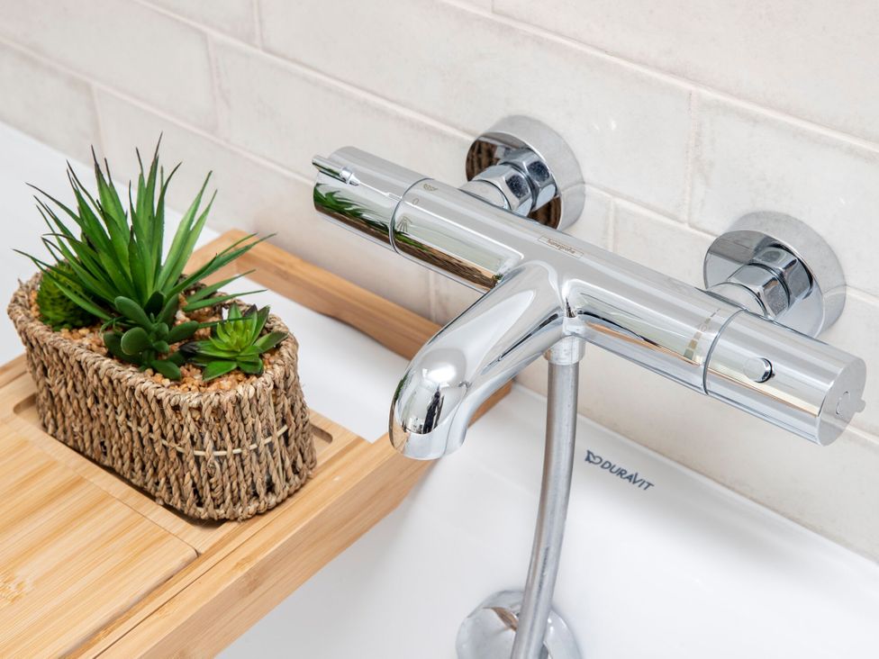 A faucet with a plant on a shelf at 2 The Croft in Skipton
