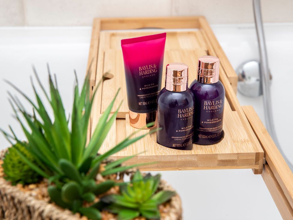 Bath tray with Baylis & Harding products and a plant at 2 The Croft Skipton
