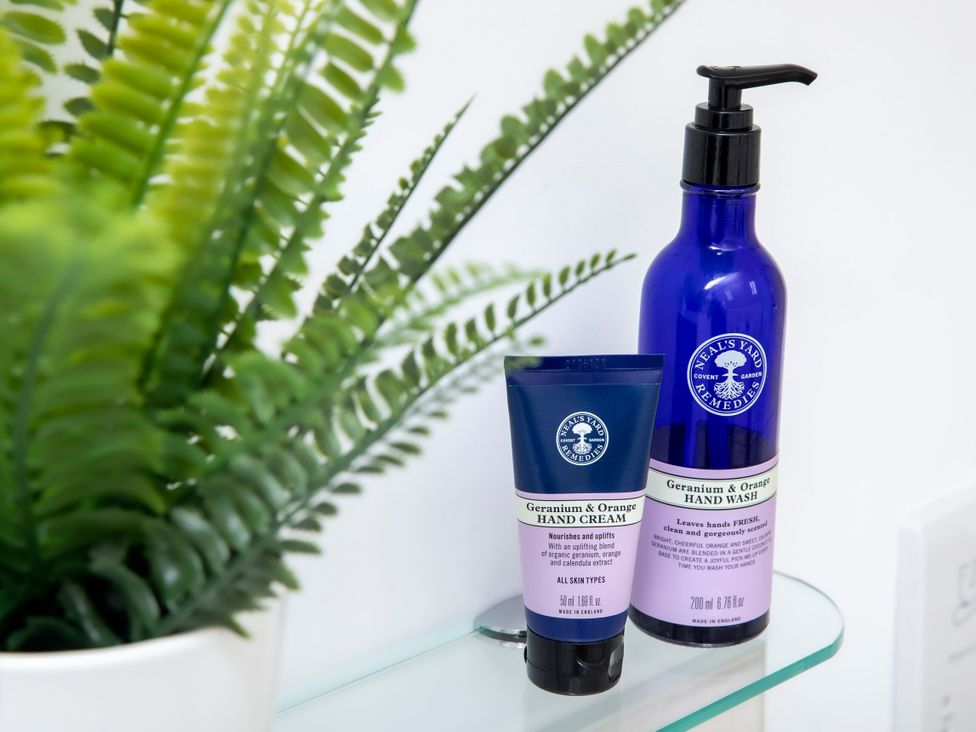A hand cream and hand wash on a shelf in a bathroom at 2 The Croft in Skipton