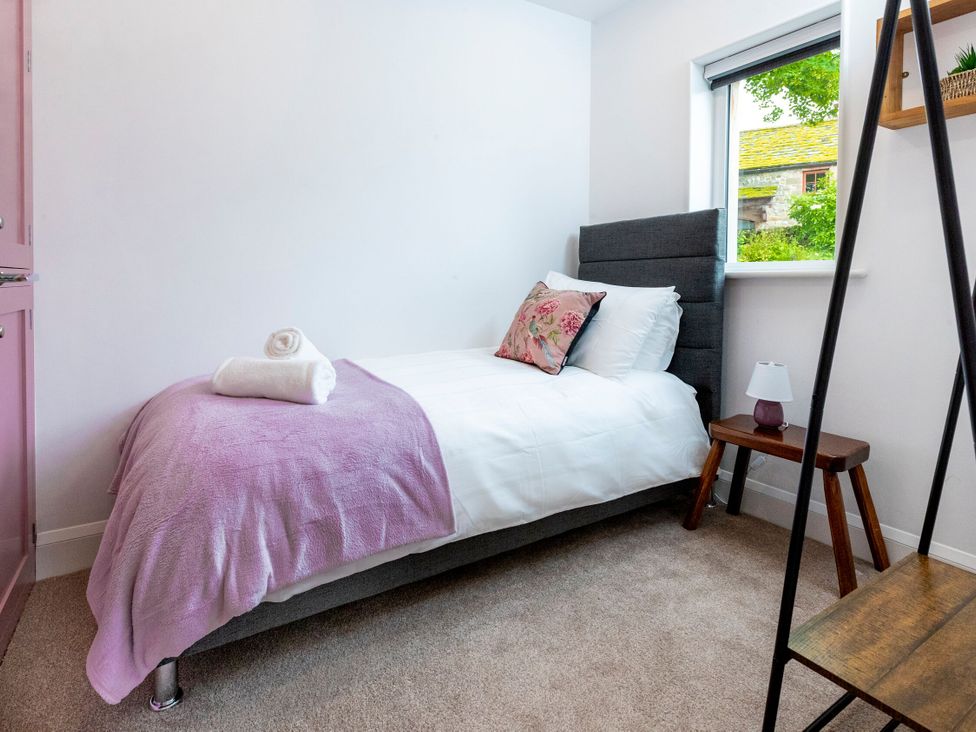 A bedroom with a single bed and a nightstand at 2 The Croft Skipton