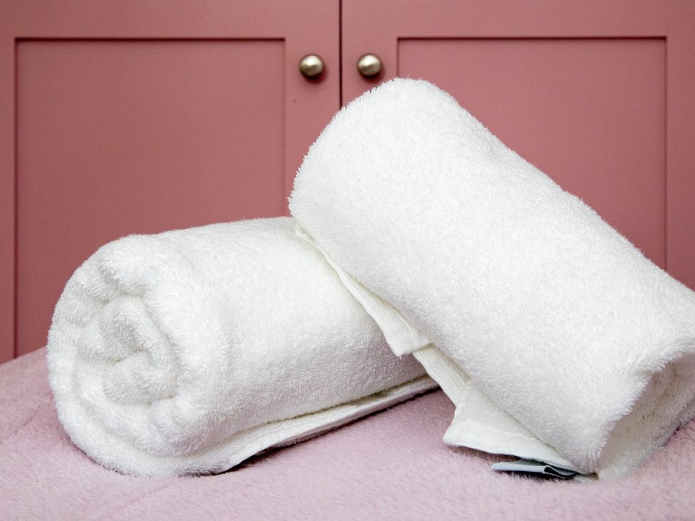 Two rolled towels on a bed at 2 The Croft in Skipton