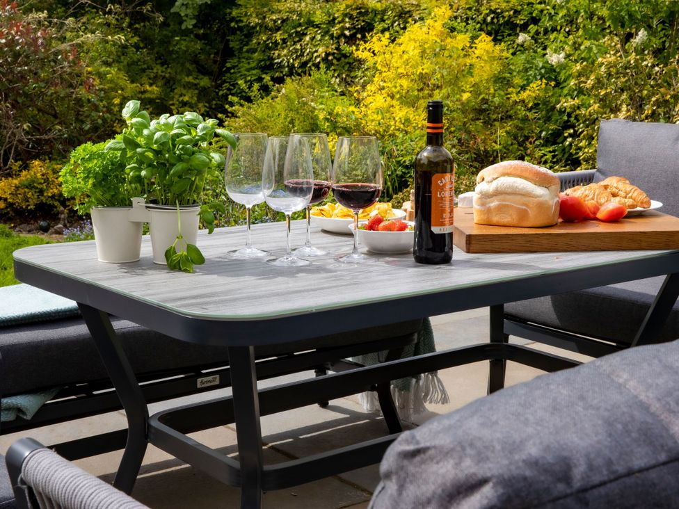 An outdoor dining area with a table set for a meal at 2 The Croft Skipton