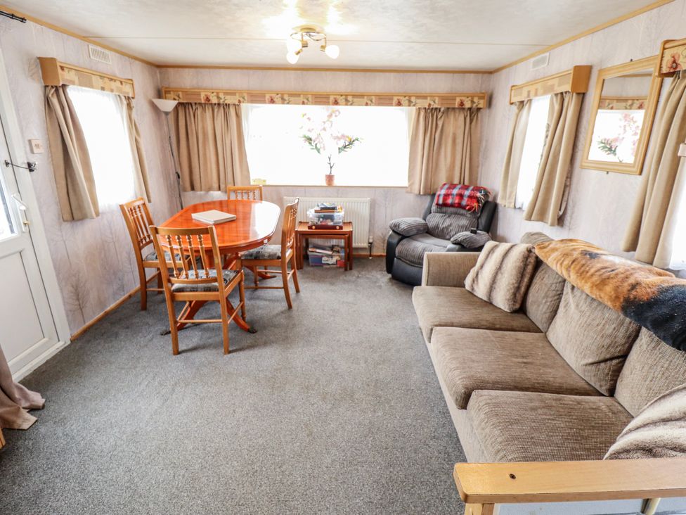A living room with a table and chairs at The Promenade in Skegness