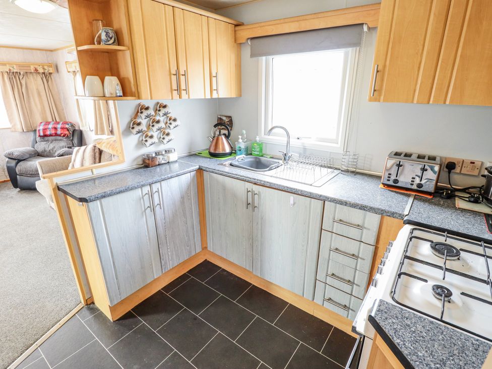 A kitchen with a sink and appliances at The Promenade in Skegness
