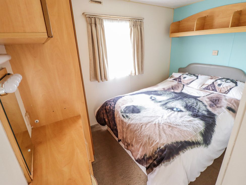 A bedroom with a bed and furniture at The Promenade in Skegness