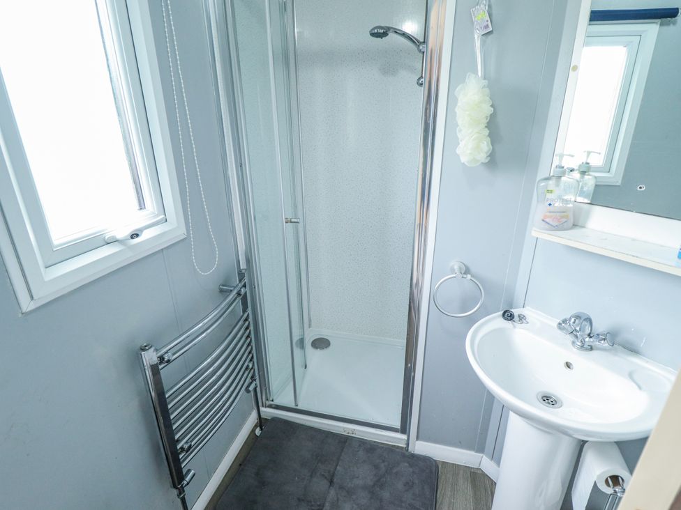 A bathroom featuring a shower and sink at The Promenade in Skegness