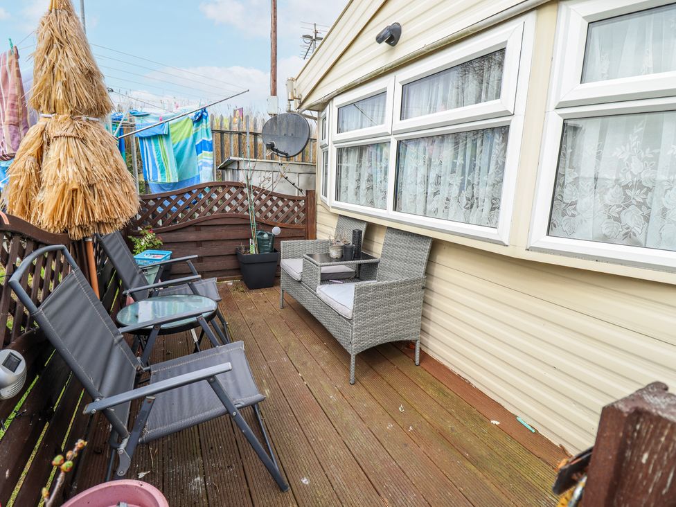 An outdoor area with chairs and a table at The Promenade in Skegness