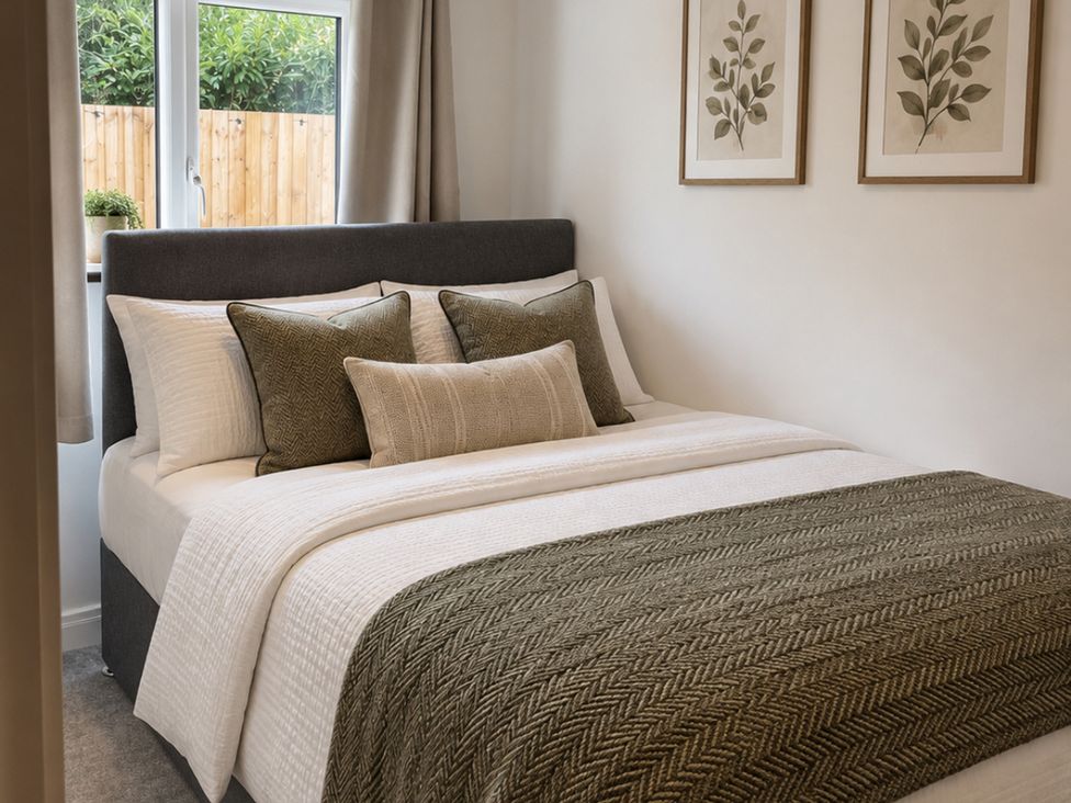A bedroom with a bed and pillows at Meadow View Cottage in Gloucester