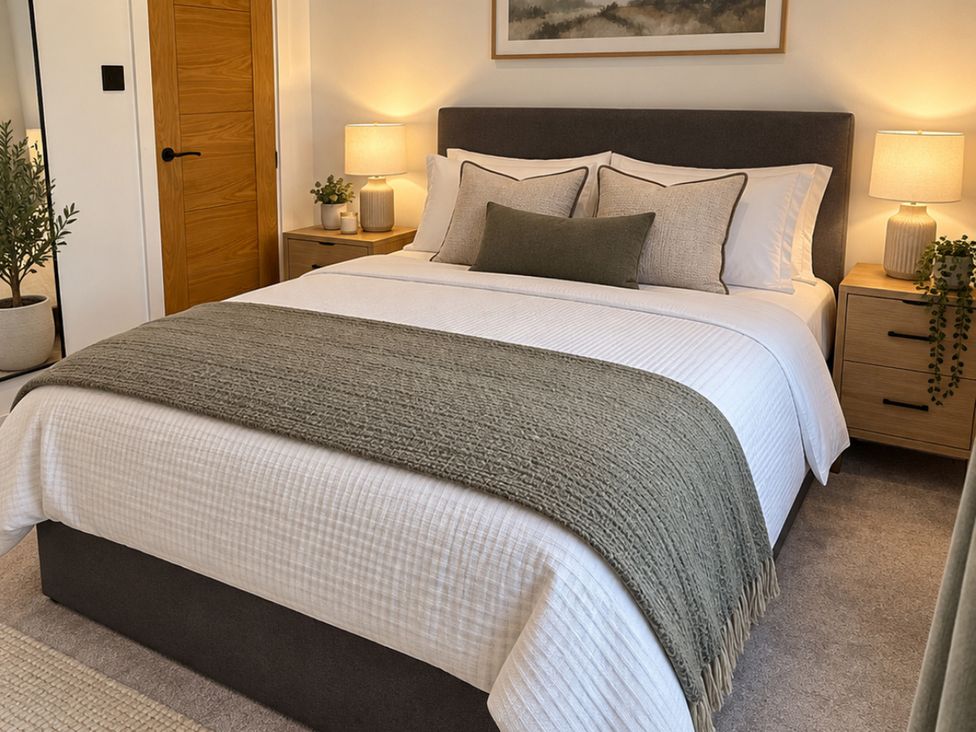 A bedroom with a double bed and bedside tables at Meadow View Cottage in Gloucester