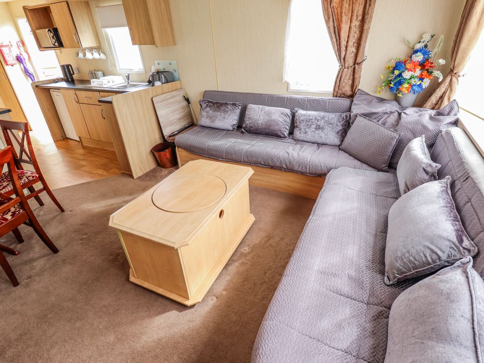 A living room with a sofa and coffee table at Seaview in Skegness