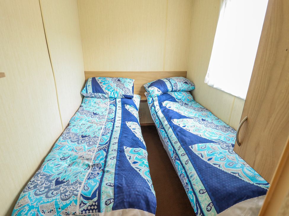 A bedroom with two single beds at Seaview in Skegness