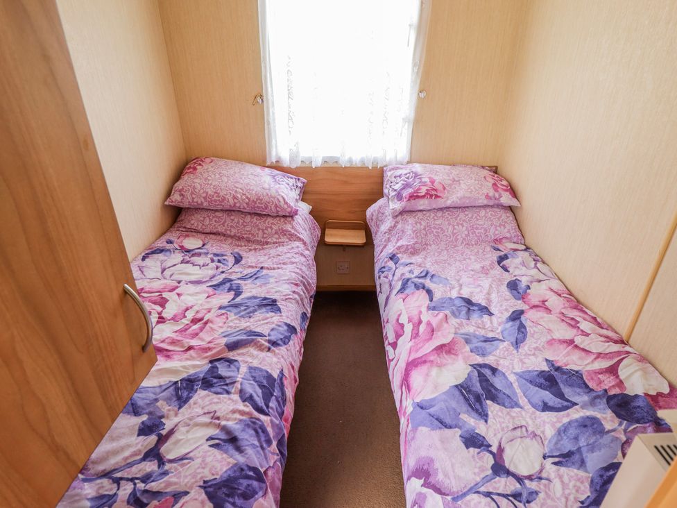 A bedroom with two single beds and a window at Seaview in Skegness