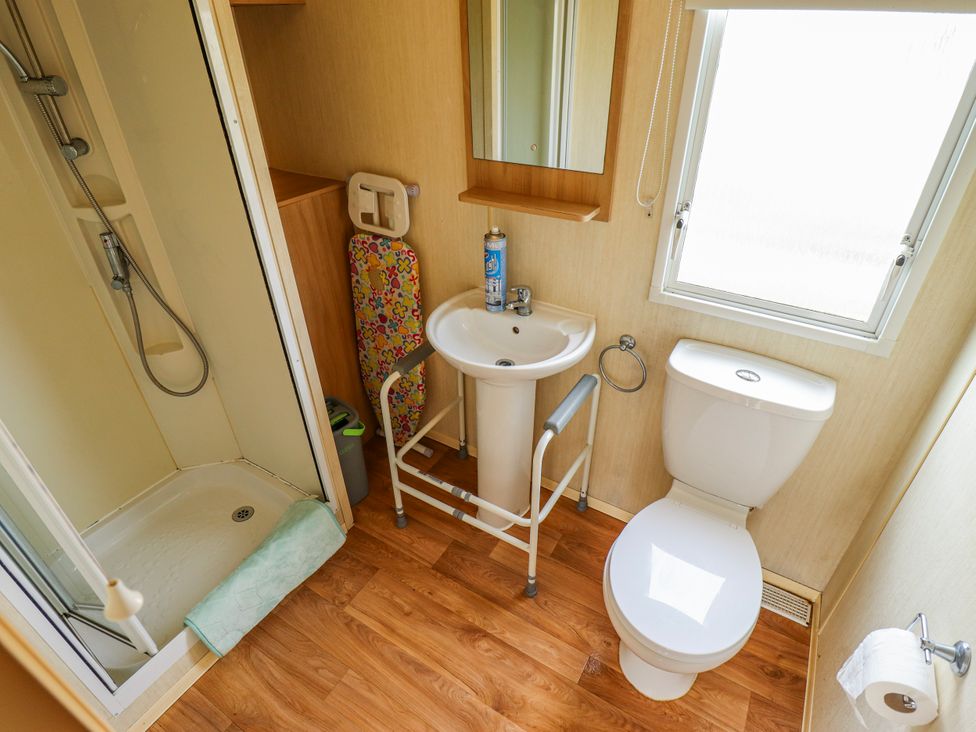 A bathroom with a shower, sink, and toilet at Seaview, Skegness