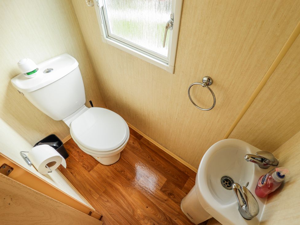 A bathroom with a toilet and sink at Seaview in Skegness