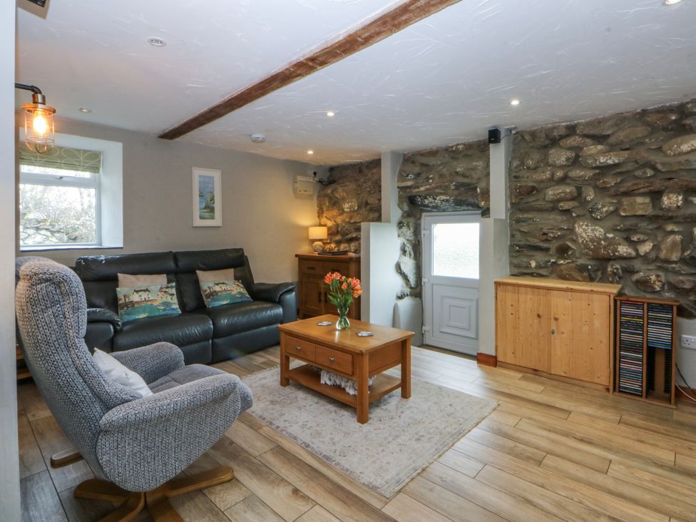 A living room with sofa and coffee table at Little Barn near Criccieth
