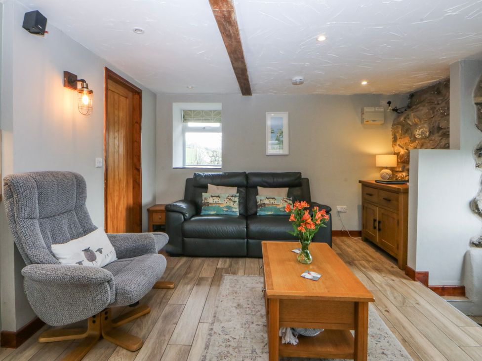 A living room with a sofa and armchair at Little Barn near Criccieth