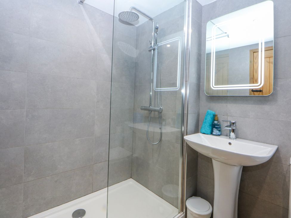 A bathroom with shower and sink at Little Barn near Criccieth