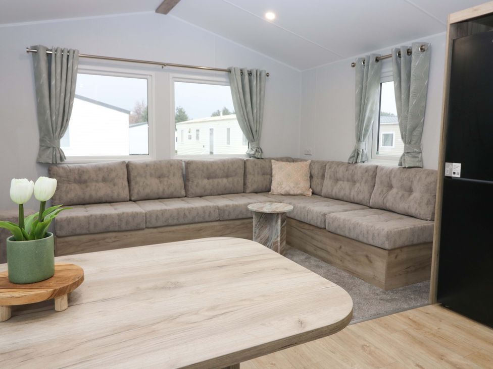 A living room with a sofa and coffee table at 63 St Andrews Prestonpans