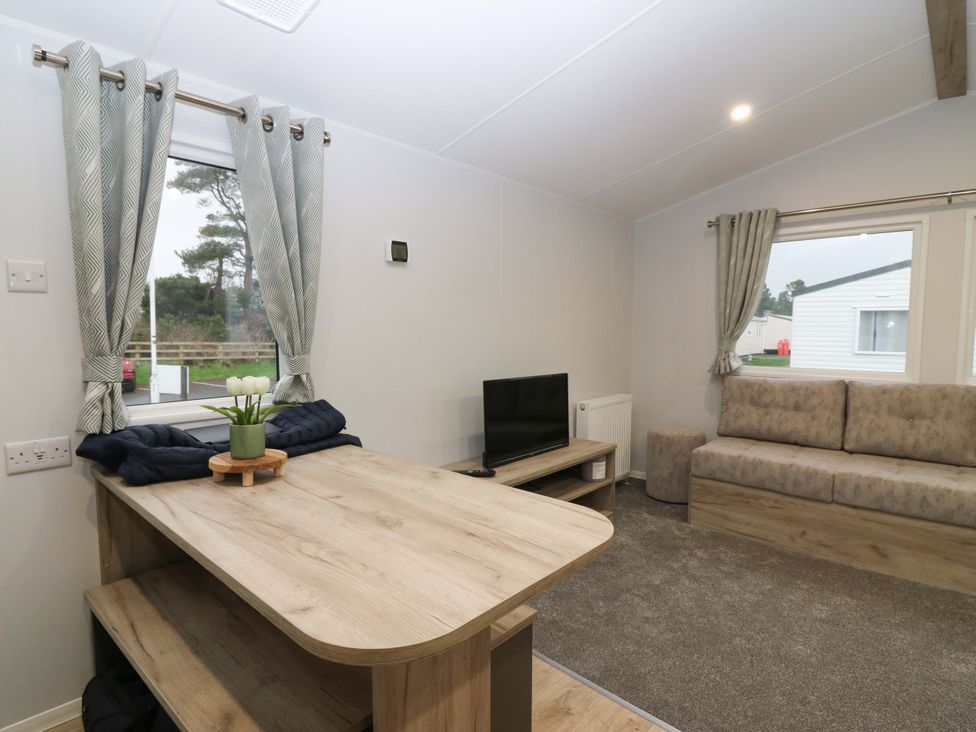 A living room with a sofa and television at 63 St Andrews in Prestonpans