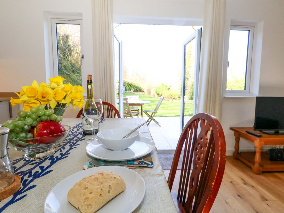 A dining room with a table set for a meal at The Pebble in Dorchester