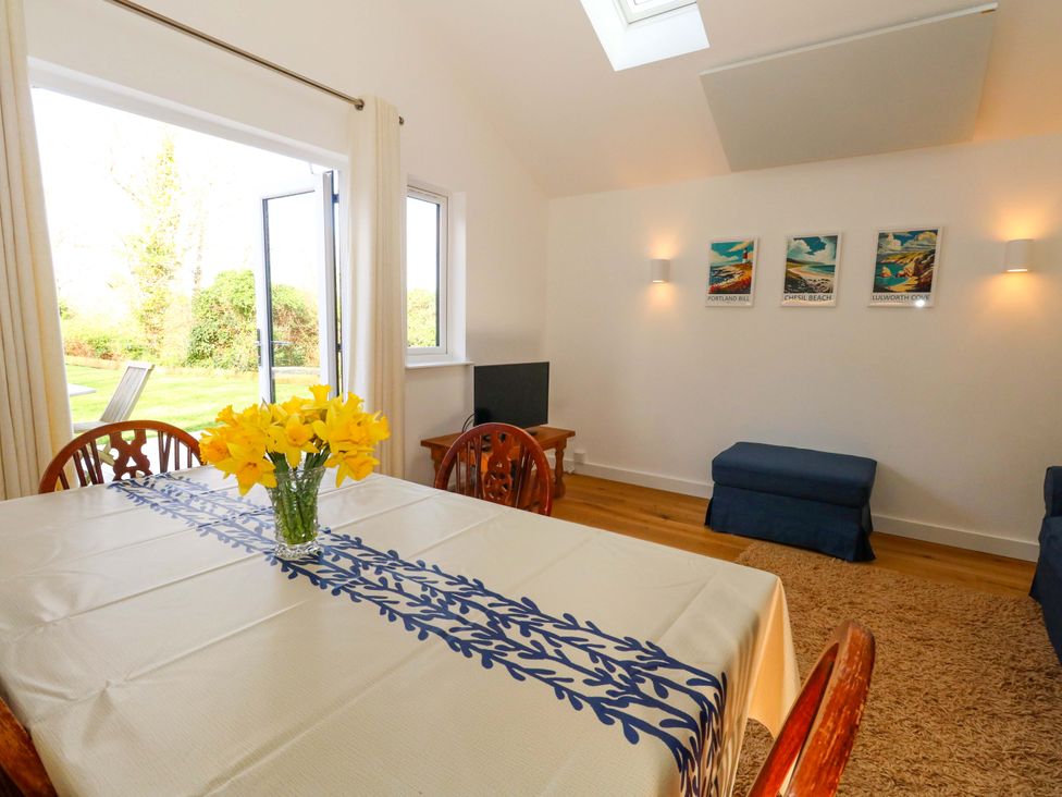 A dining room with a table and chairs at The Pebble in Dorchester