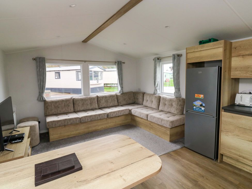 A living room with a sofa and television at Valley 36 in Kingsbridge