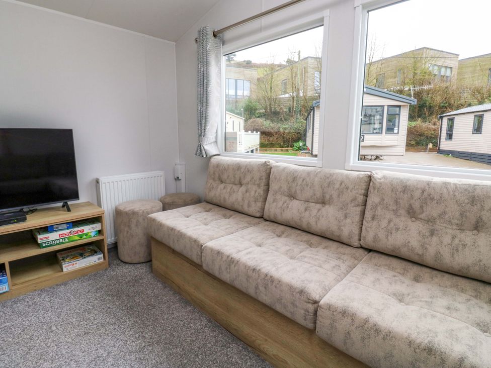 A living room with a sofa and television at Valley 36 in Kingsbridge