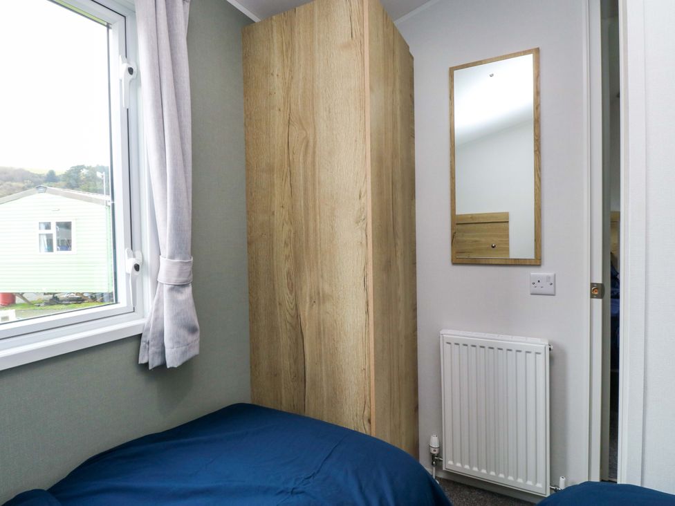 A bedroom with a bed and wardrobe at Valley 36 in Kingsbridge