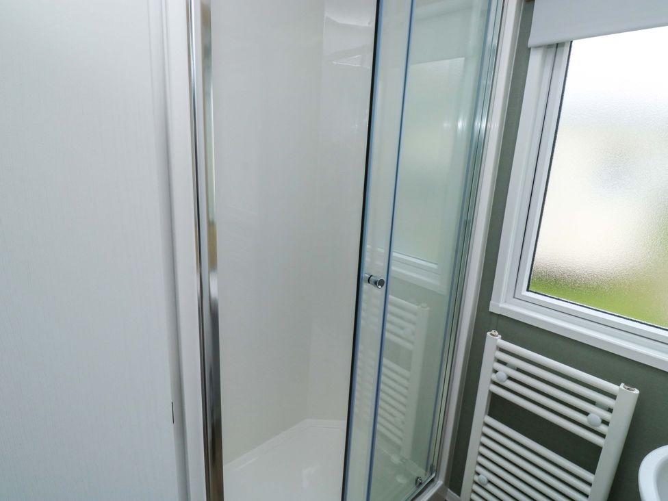 A bathroom with a shower and towel radiator at Valley 36 in Kingsbridge