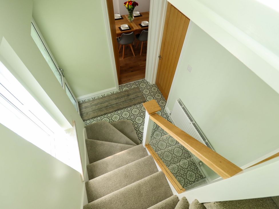 A staircase with a view of the dining area at 271 Wragby Road Lincoln