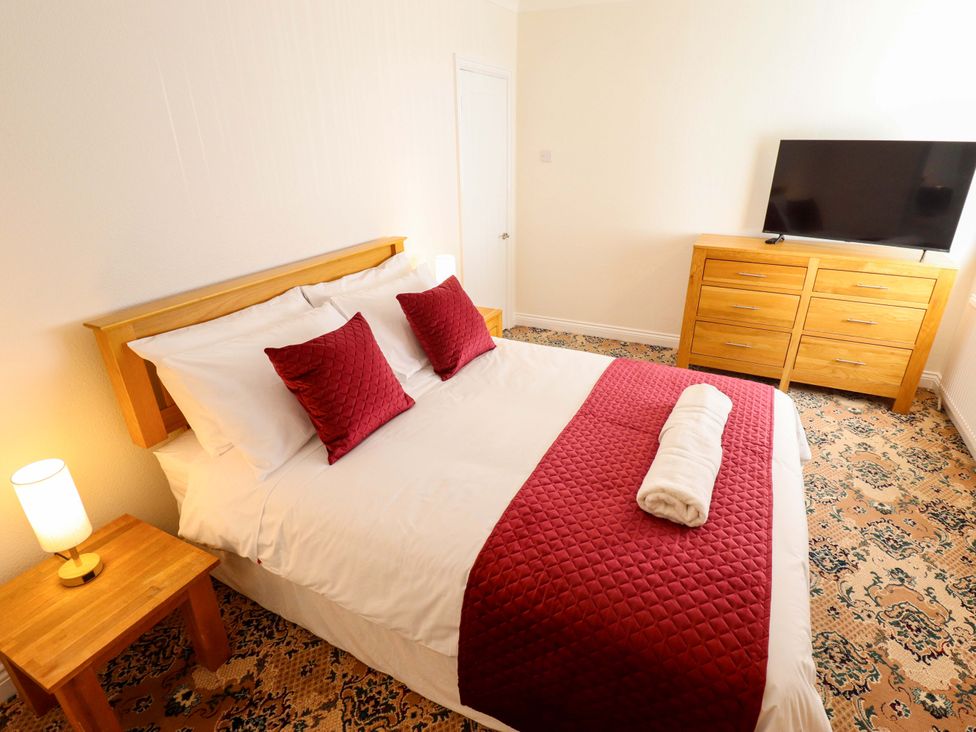 A bedroom with a bed and television at 271 Wragby Road in Lincoln