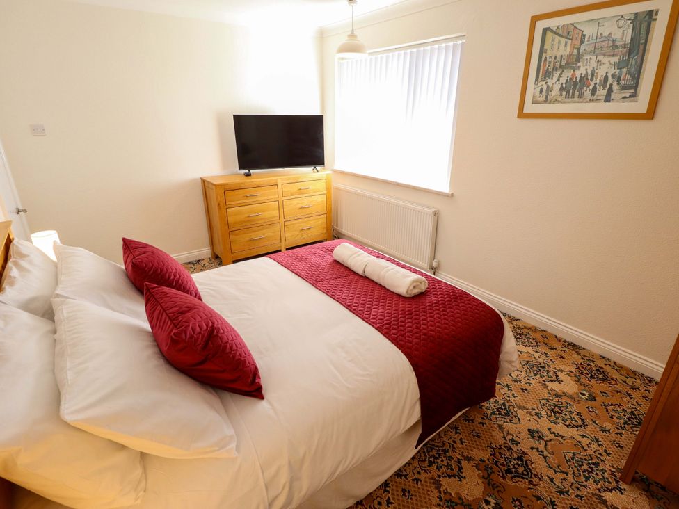 A bedroom with a bed and television at 271 Wragby Road in Lincoln