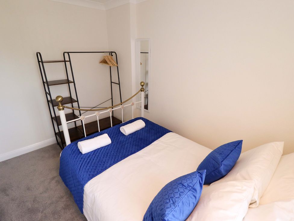 A bedroom with a bed and a shelf at 271 Wragby Road in Lincoln