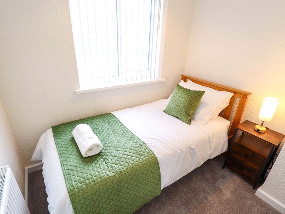 A bedroom with a single bed and window at 271 Wragby Road, Lincoln