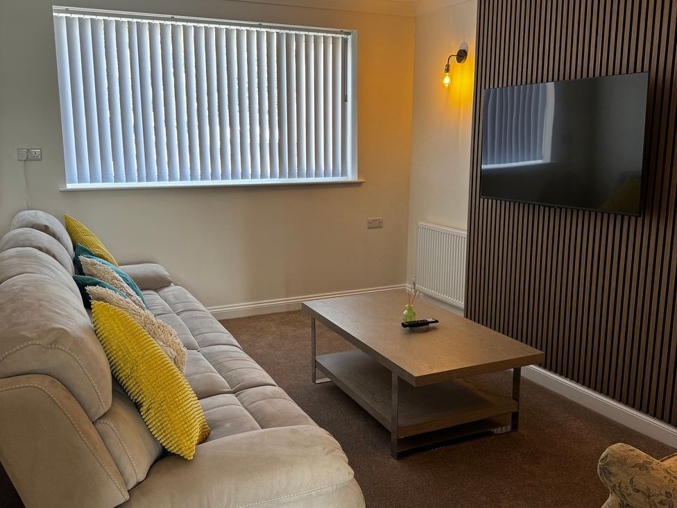 A living room with a sofa and television at 271 Wragby Road Lincoln