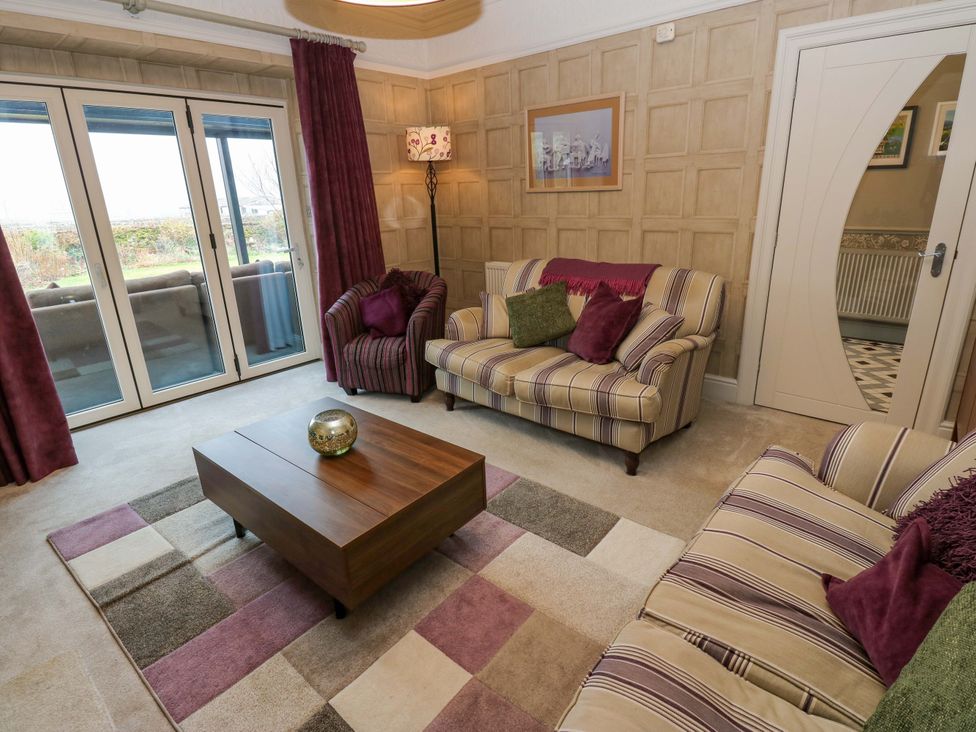 A living room with a sofa and coffee table at Langcliffe House in Kettlewell