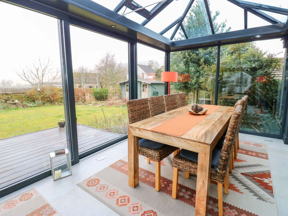 A dining area with a table and chairs at Langcliffe House in Kettlewell