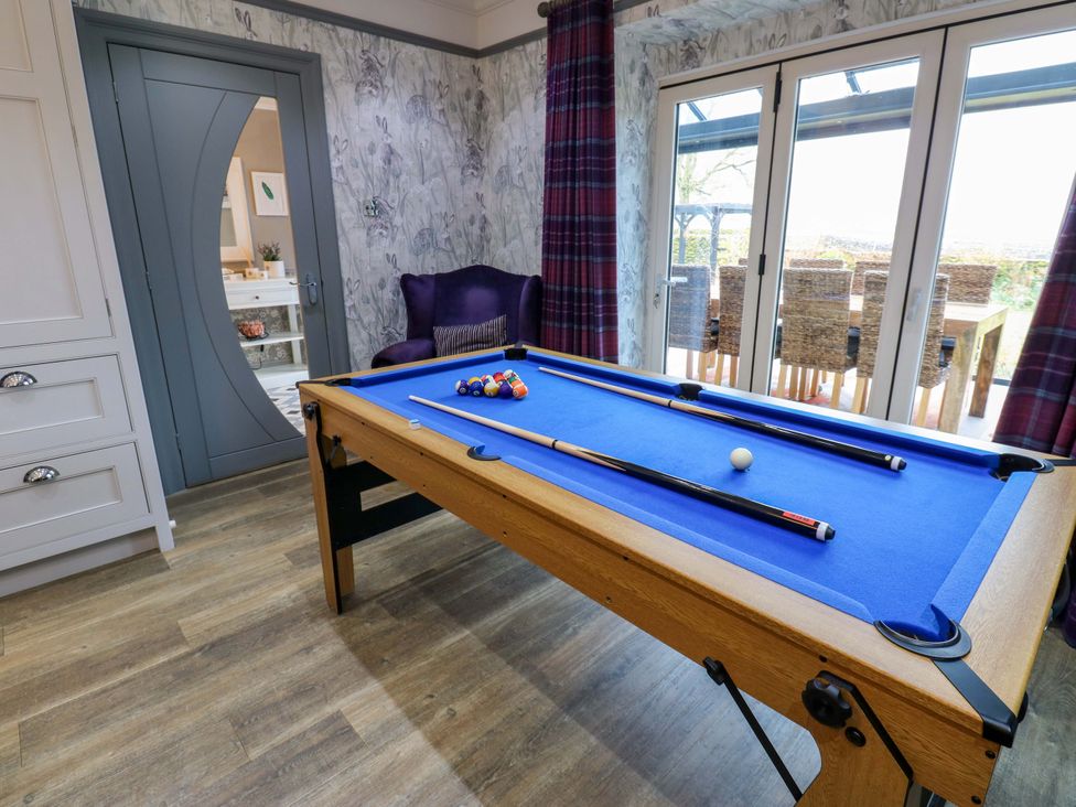A games room with a pool table and armchair at Langcliffe House Kettlewell