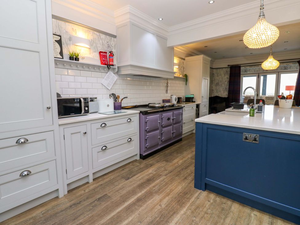 A kitchen with cabinets and appliances at Langcliffe House Kettlewell