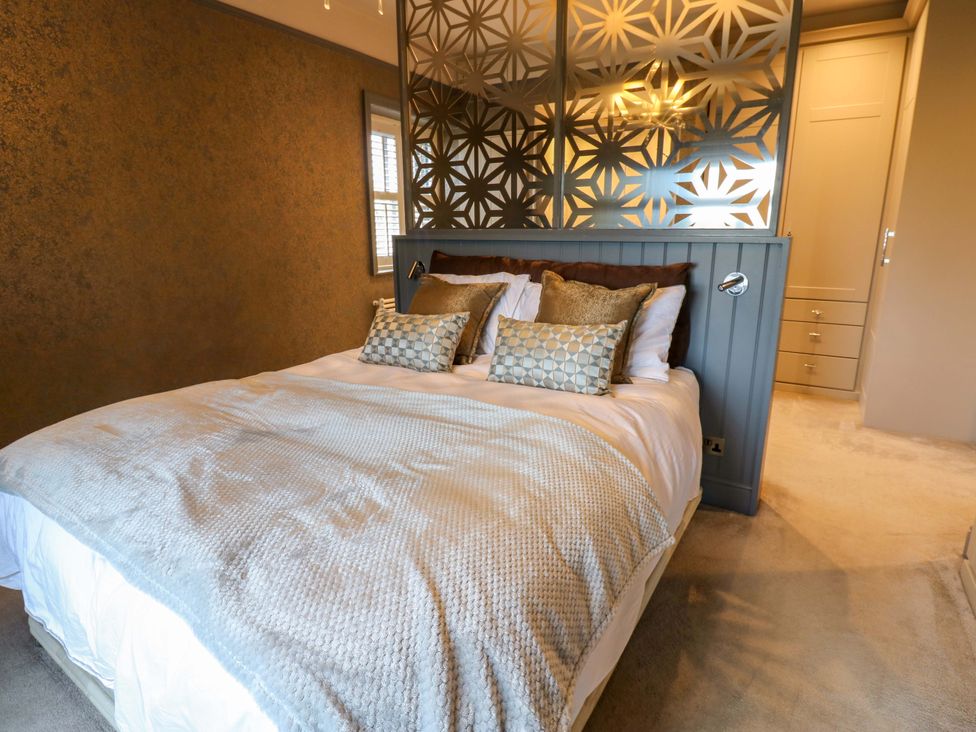 A bedroom with a bed and decorative wall at Langcliffe House Kettlewell