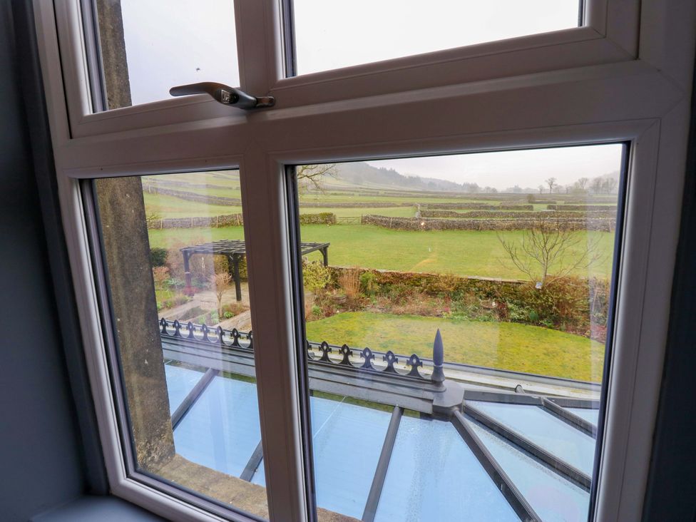 A view from a window showing a garden and landscape at Langcliffe House Kettlewell